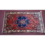 A North West Persian Tafresh rug, the central pendant medallion, on a rouge field, complimented by a