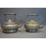 A pair of 20th century middle eastern pewter tea pots, stamped to base