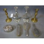 A collection of silver plate items including three brushes, two pairs of candlestick and one box
