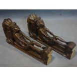 A pair wood carvings of Atlas or Telamons (male versions of caryatids) in the fashion of shelf