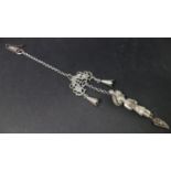 A late 19th century Chinese white metal chatelaine, with bells, pierced fish plaque and figure of