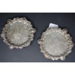 A pair of George II silver salvers by Benjamin Godfrey, London 1739, each circular and on three
