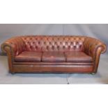 A three seater leather Chesterfield sofa, with button back upholstery, heavily worn, H70cm,