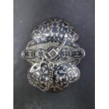 A Russian silver niello belt buckle, decorated with script and scrolls, with dagger fastener,