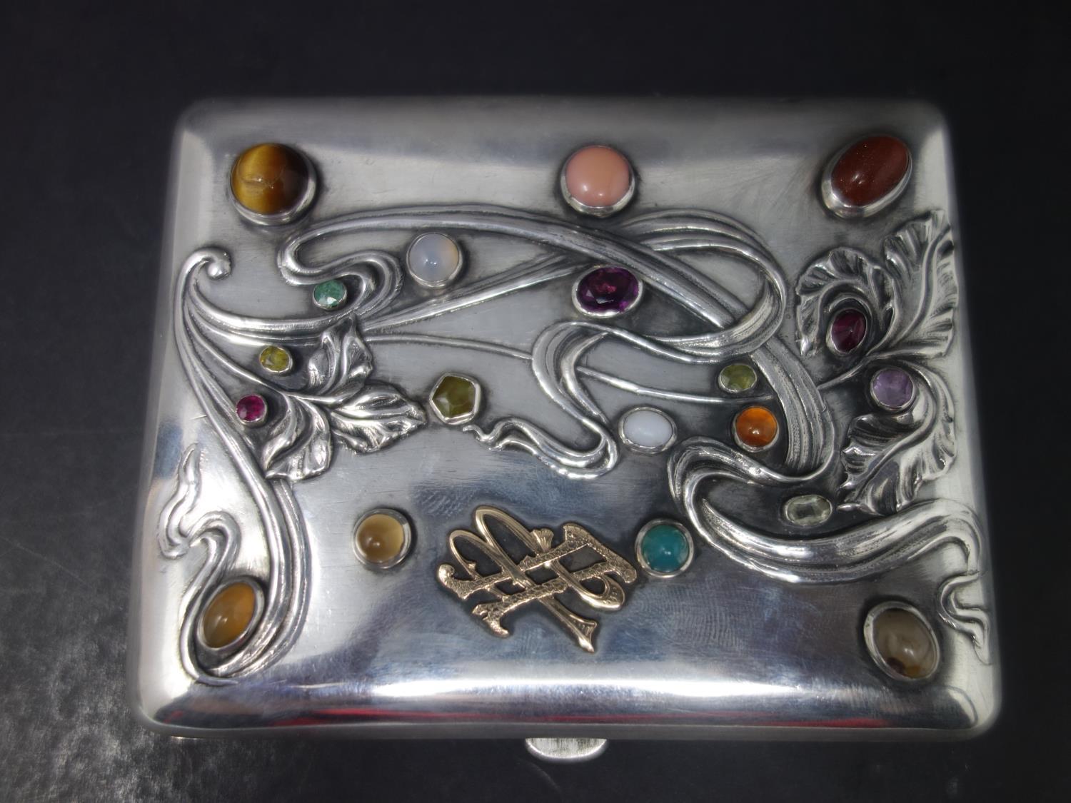 A 19th century Russian silver cigarette case, set with semi-precious and precious stones, to include