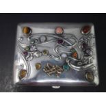 A 19th century Russian silver cigarette case, set with semi-precious and precious stones, to include