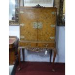 An early 20th century burr walnut cocktail cabinet, H.159 W.92 D.49cm