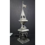 A 19th century Russian silver spice tower, with steeple top having flag, with four figures holding