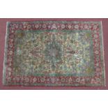 An antique part silk Persian Isfahan Sarafian rug, central floral medallion and stylised flowers