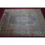 A Central Persian Kirman carpet with central diamond double pendant, with repeating petal motifs,