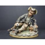 A Capodimonte (Naples) porcelain figure by Cortese representing a tramp drinking, H.23 x W. 23 x