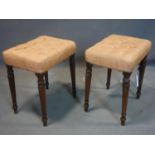 A pair of 19th century mahogany stools, with pink satin buttoned upholstered seats, on turned