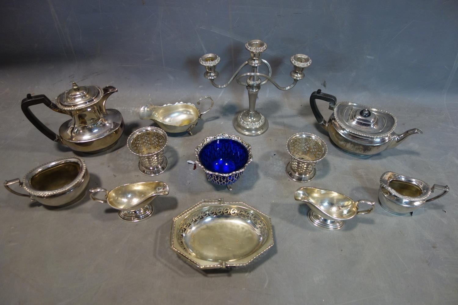 A collection of silver plated items, including a teapot and coffee pot, two sauce gravy boats, one