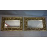 A pair of carved and pierced gilt wood mirrors with bevelled plate, 86 x 56cm