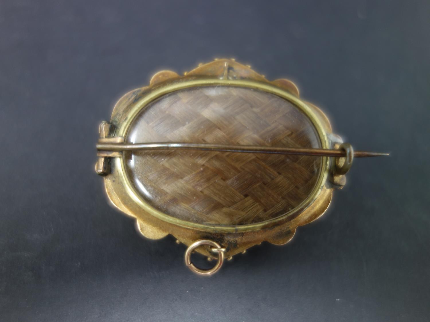 A Victorian yellow metal memento mori brooch, with scrolling decoration and central seed pearl in - Image 3 of 3