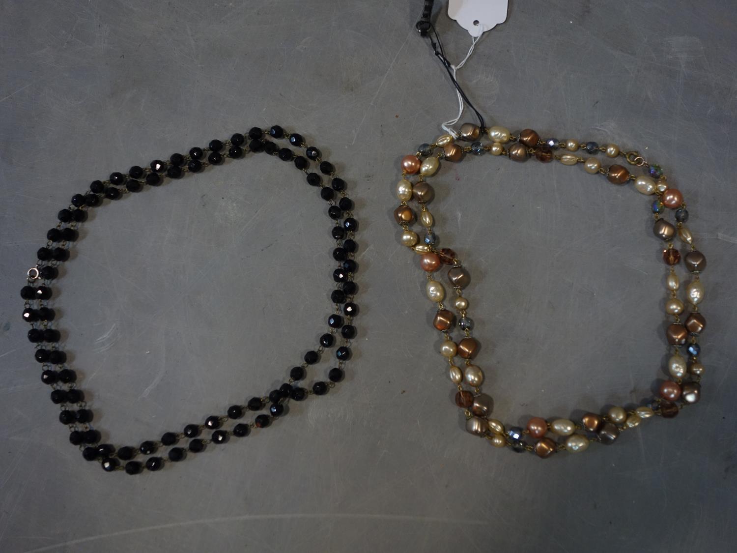 A jet faceted beaded necklace together with a faux pearl and beaded necklace