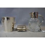 A silver plated ice bucket, casket shaped jewellery box and a cut glass lemonade jug