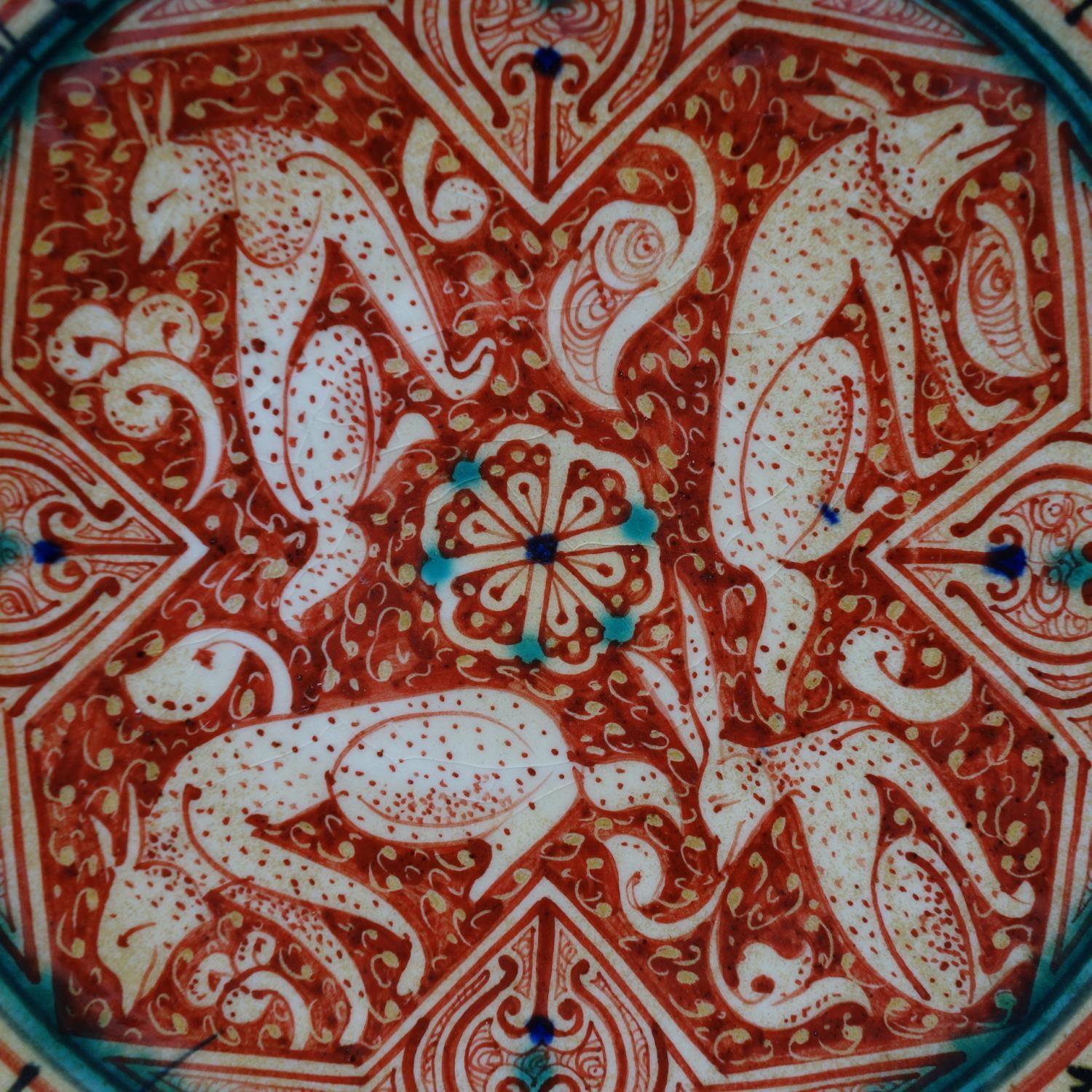 A Persian glazed ceramic plate, decorated with jackals from fables of a Buddhistic source translated - Image 2 of 6