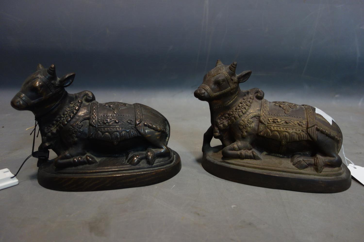 A pair of 20th century Indonesian cast bronze cows, H.17 W.22 D.11cm - Image 2 of 2