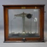 A set of vintage weighing scales by Griffin & George, with Bakelite base, set in glass case by F.E