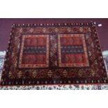 A bokhara style rug on burgundy ground