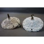 A pair of white painted cast iron ceiling hooks