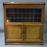 A 20th century Globe Wernicke style oak bookcase, with leaded glass sliding door above two