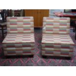 A pair of contemporary chairs in striped fabric