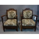 A pair of 20th century oak armchairs, with RAF insignia and wings to top rail, the upholstery with