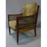 A 19th century mahogany Bergere armchair, with caning to backrest, sides and seat, having two