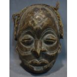 A Southern African tribal mask from the Chokwe people, Angola, with scarification, chip to lip,