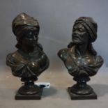 A pair of 20th century bronze busts of an Arabian man and woman, H.30cm