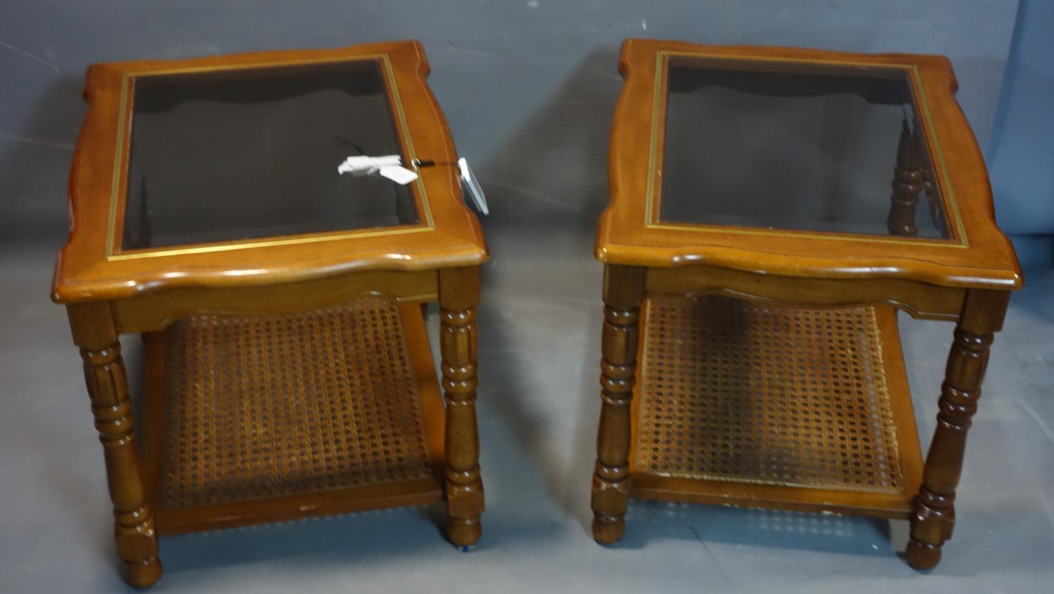 Two solid wood coffee tables, with bevelled glass tops, with rattan undertier, on turned supports,