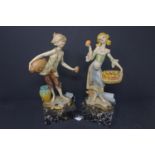 A pair of porcelain figures of a boy and a girl on marble bases, 1960's, H 24cm