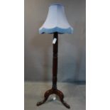 A Victorian carved mahogany standard lamp, with blue shade, H.135cm