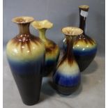 Four Persian drip glazed vases of varied size and form, H.39cm (largest)