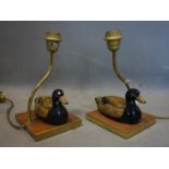 A pair of brass table lamps with ceramic models of ducks, with label tag for Christopher Wray