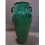 A Persian green glazed Sharab wine vessel, H.76cm