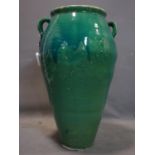 A Persian green glazed Sharab wine vessel, H.73cm