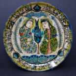 A Persian glazed ceramic plate, made in Tehran, date and makers mark to reverse, depicting a Persian