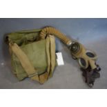 A military issue gas mask with canvas bag