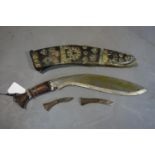 A dagger, brass clad and inset with turquoise, with two small blades, L.43cm