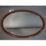 A mahogany inlaid oval wall mirror, with bevelled glass plate, 60 x 89cm