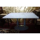 A rectangular marble topped table, on metal twin baluster supports on oval base, H.73 W.120 D.80cm
