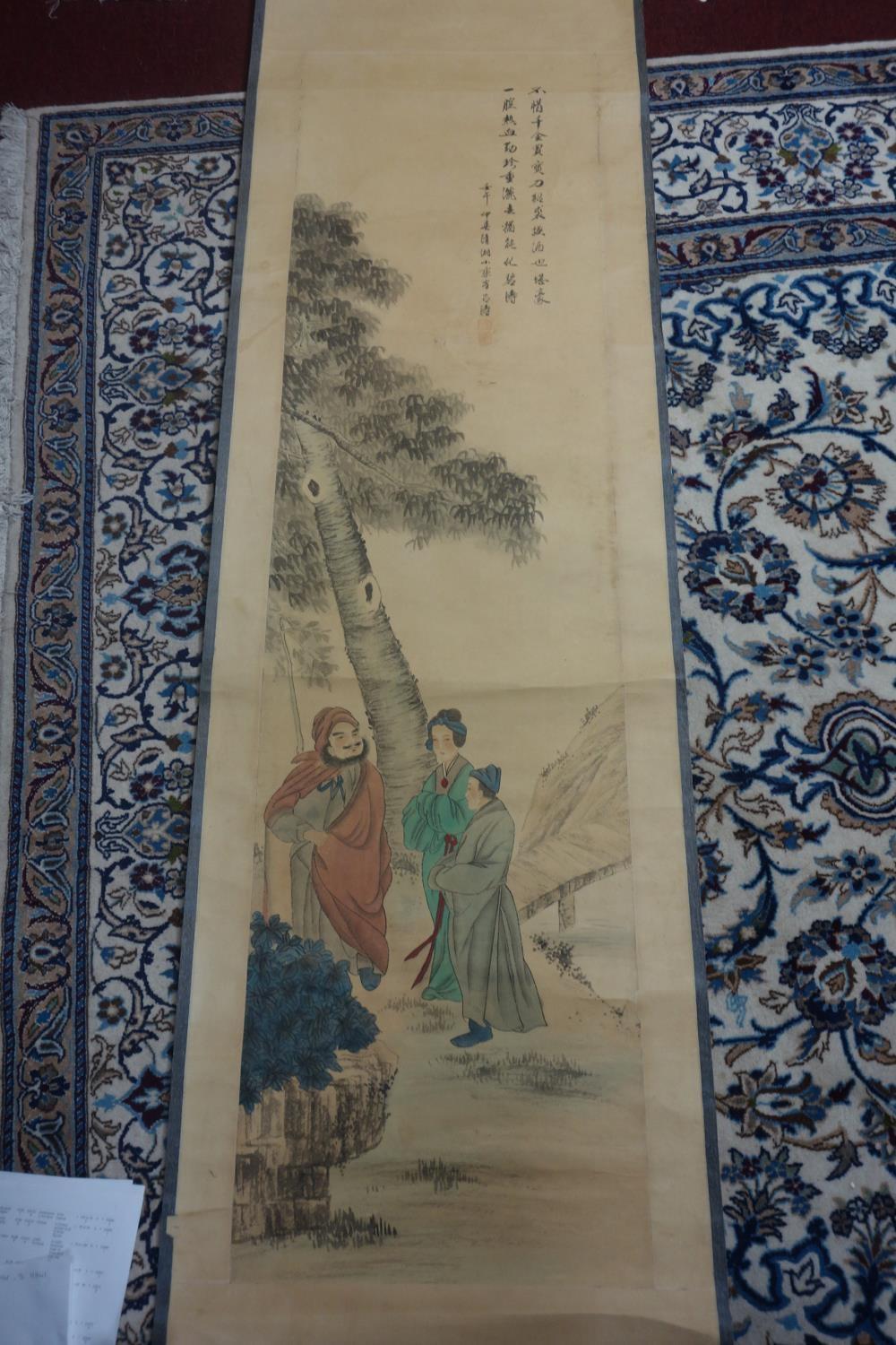 A Chinese printed scroll of three figures under a tree by a bridge, bearing Chinese characters,