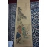 A Chinese printed scroll of three figures under a tree by a bridge, bearing Chinese characters,