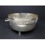 A large silver twin handled bowl, with inscription, on tripod feet, London 1928, approx. 26.1 troy