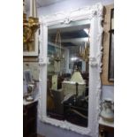 A large pier mirror with a frame decorated by carvings of putti and painted in white, 120 x 207 cm