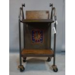 An early 20th century Industrial two tier drinks trolley, raised on Flexello castors, H.106 W.55 D.