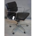 An Eames style swivel desk chair